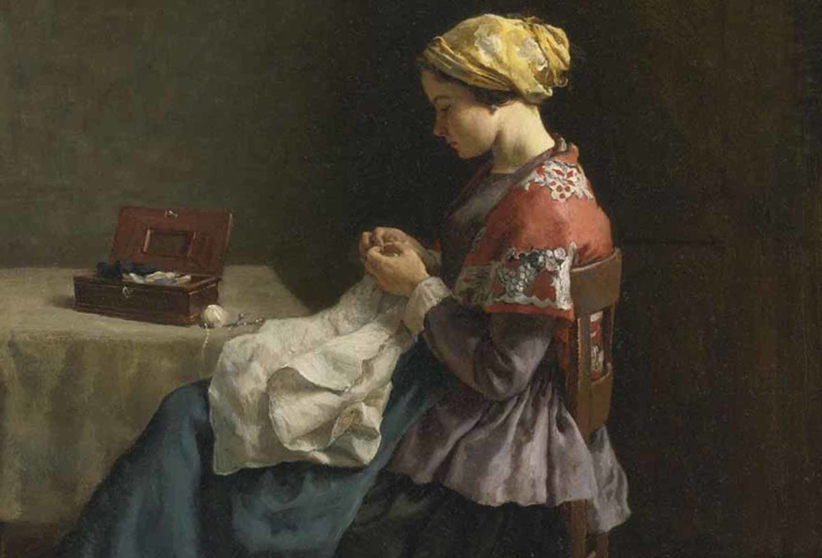 Couturière cousant assise à sa table, sur laquelle est posée une boîte à couture ouverte
